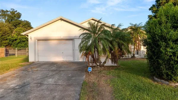 a view of a house with a yard and garage