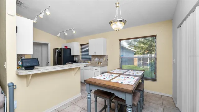 a kitchen with a table chairs and a stove