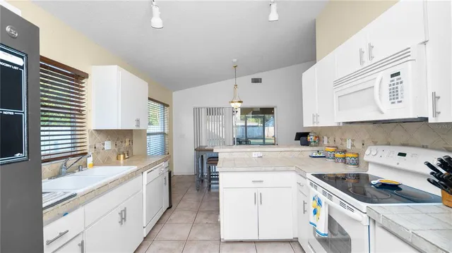 a kitchen with a sink stove and cabinets