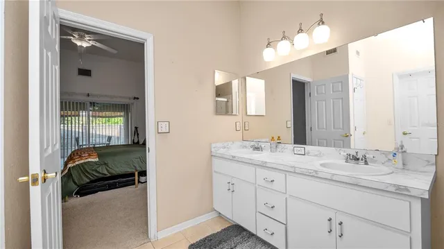 a en suite bathroom with a sink double vanity and mirror
