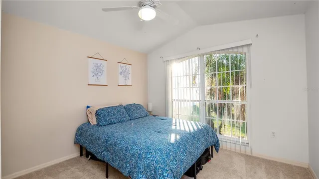 a bed sitting in a bedroom next to a window