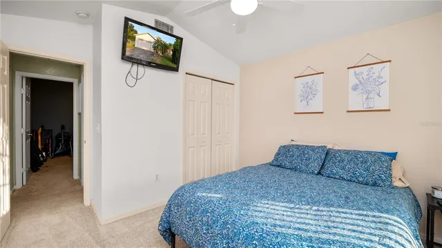 a bedroom with a bed and a painting on the wall