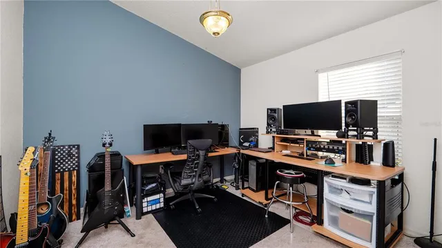 a view of a workspace with furniture and a window