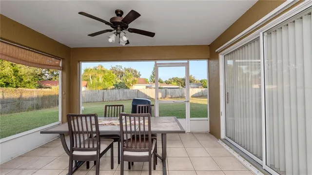 a view of a porch with furniture and a yard