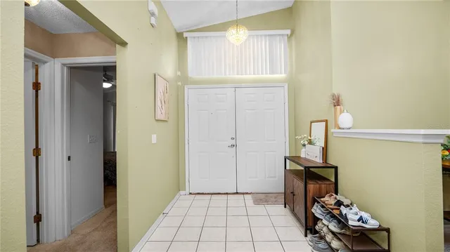 a view of a hallway to room with wooden floor and closet
