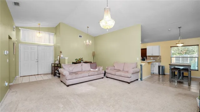 a living room with furniture and a chandelier