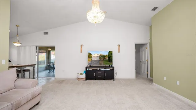 a living room with furniture and a chandelier
