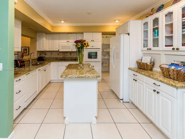 a kitchen with granite countertop a sink and cabinets