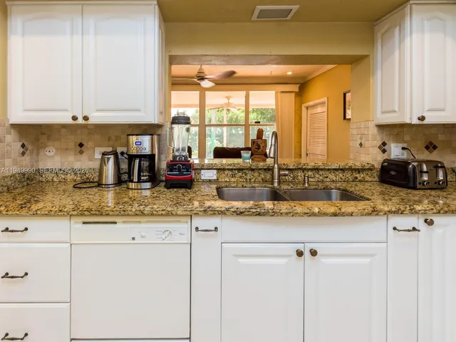 a kitchen with a refrigerator and cabinets