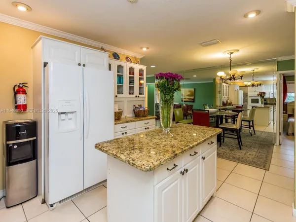 a kitchen with stainless steel appliances granite countertop a refrigerator and a stove
