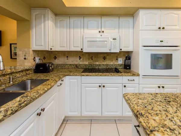 a kitchen with granite countertop a sink and a window