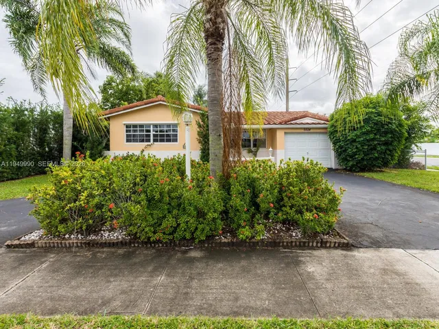 a front view of a house with a yard and a garage