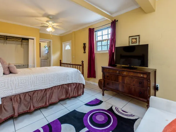 a bedroom with furniture and a flat screen tv