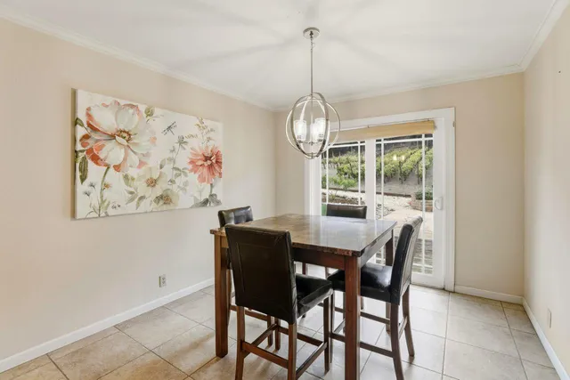 a kitchen with stainless steel appliances granite countertop a stove top oven a sink island and chairs