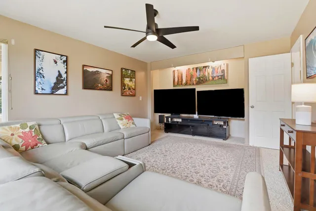 a bathroom with a granite countertop toilet sink shower and mirror
