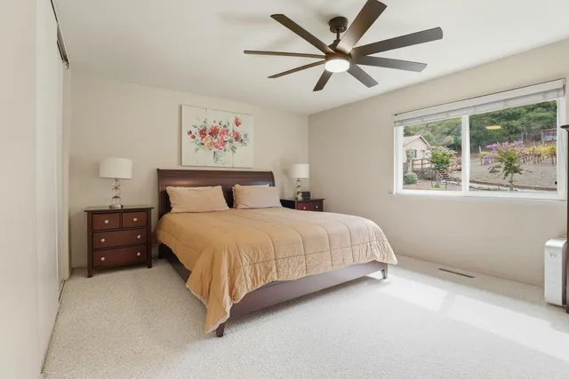 a bedroom with a large bed and a window