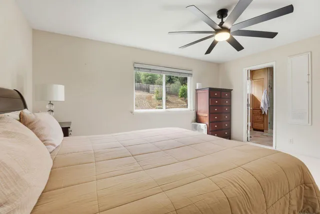 a view of a backyard with table and chairs under an umbrella with a small yard