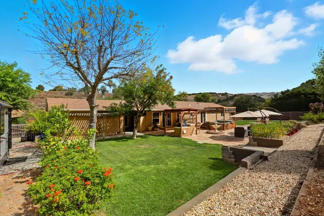 a front view of house with backyard and green space