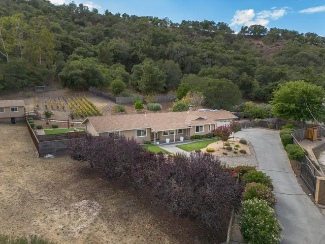an aerial view of a house with a yard basket ball court and outdoor seating