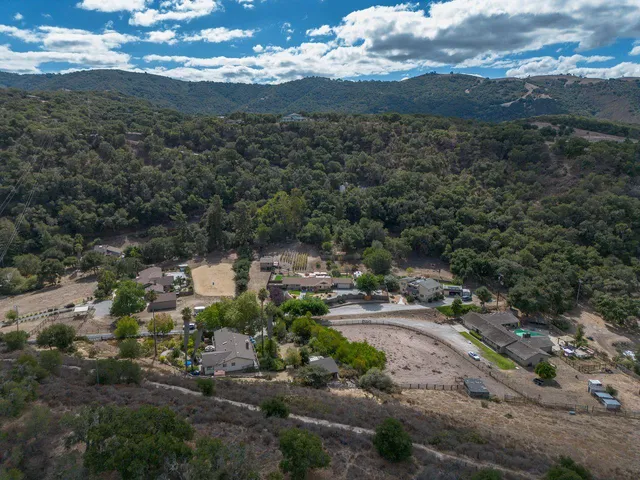 an aerial view of a house with garden space and street view