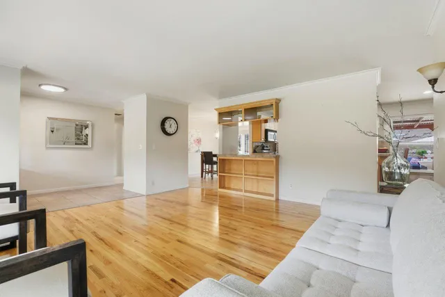 a view of a dining room with furniture large window and chandelier