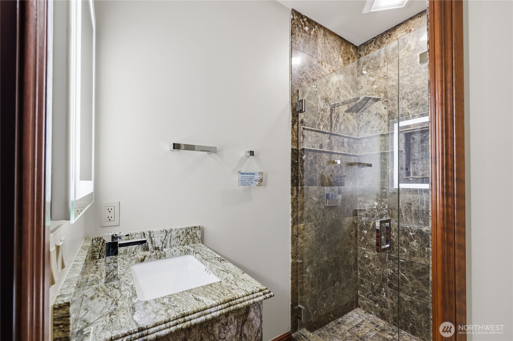 1411 Thorndyke Road Port Ludlow, WA 98365 - Photo 26 of 40 a bathroom with a granite countertop shower a sink and a mirror