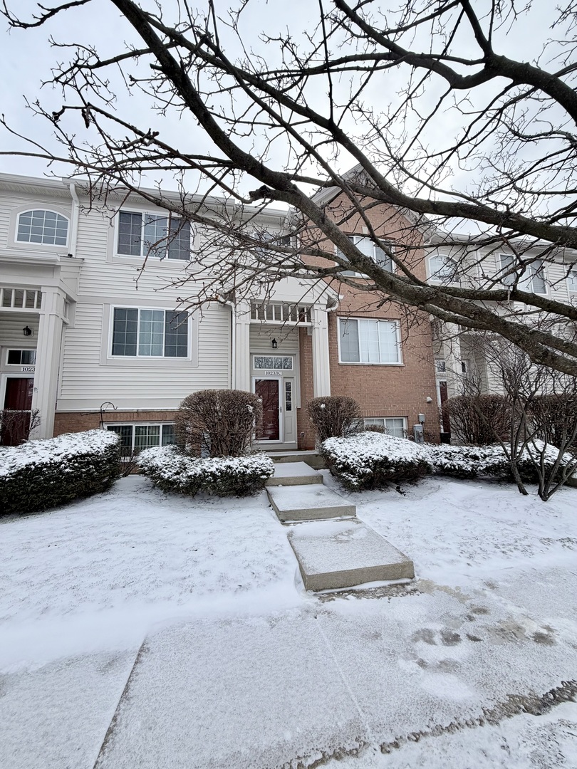 a view of a house with a snow in front of a house