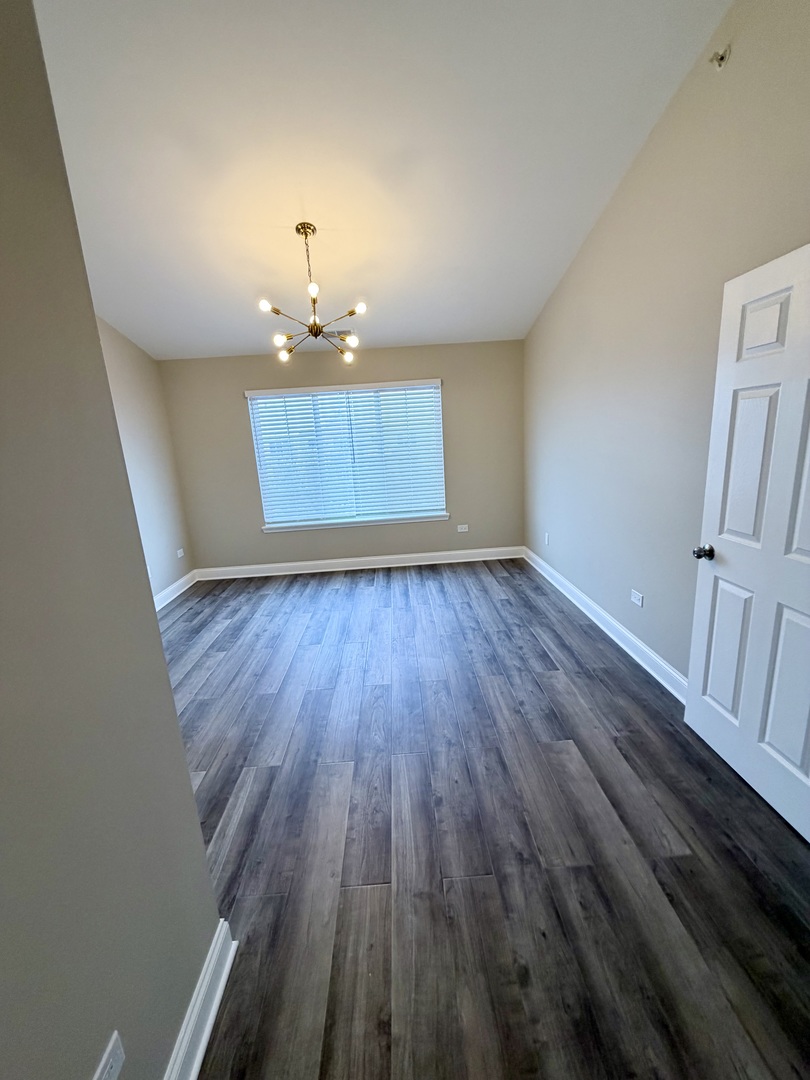 10233 Concord Lane, Unit C Bridgeview, IL 60455 - Photo 14 of 23 wooden floor in an empty room with a window