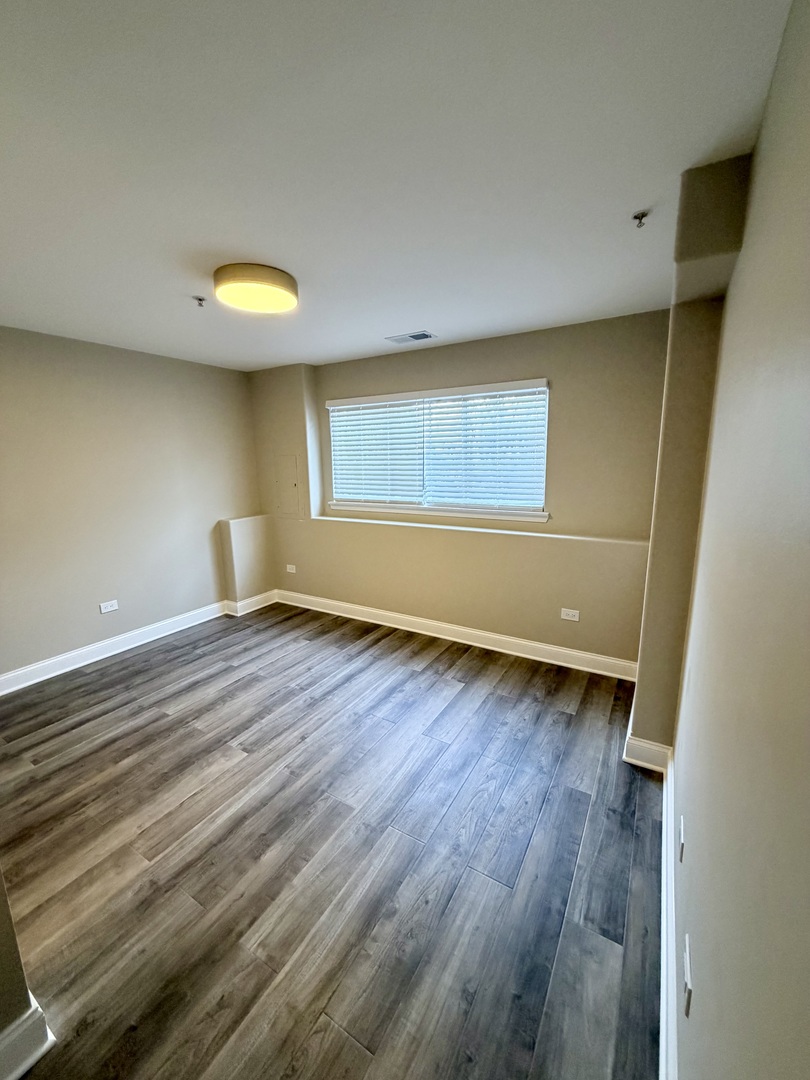 10233 Concord Lane, Unit C Bridgeview, IL 60455 - Photo 21 of 23 a view of empty room with wooden floor