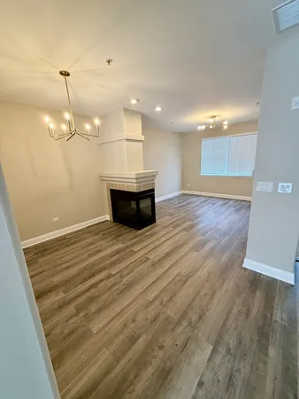 a view of a room with wooden floor and flat screen tv
