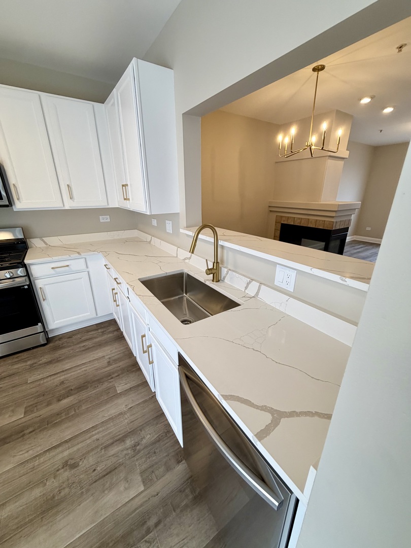 10233 Concord Lane, Unit C Bridgeview, IL 60455 - Photo 8 of 23 a kitchen with a sink and cabinets