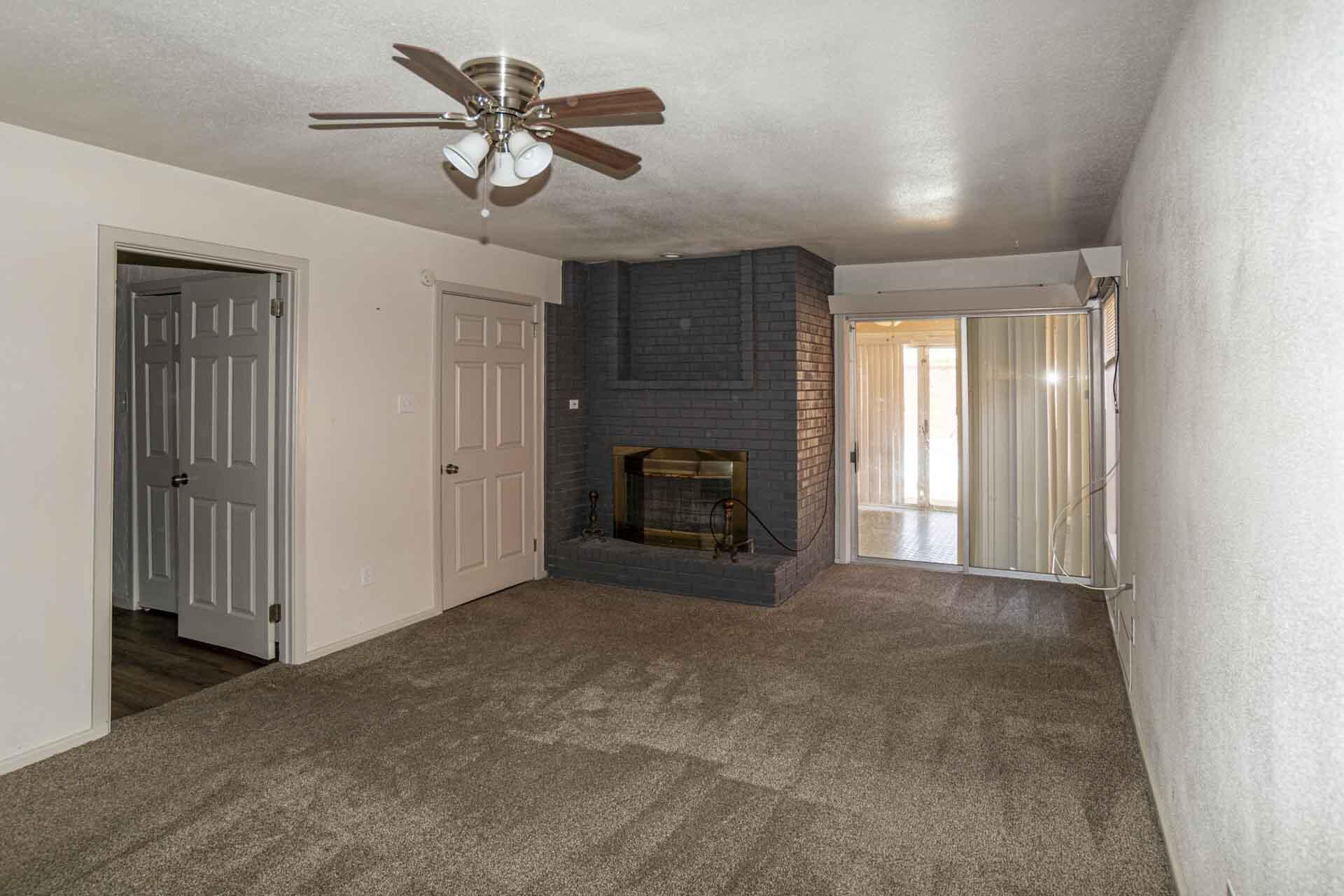 2136 57th Street Lubbock, TX 79412 - Photo 16 of 41 a view of a livingroom with a chandelier fan and a fireplace