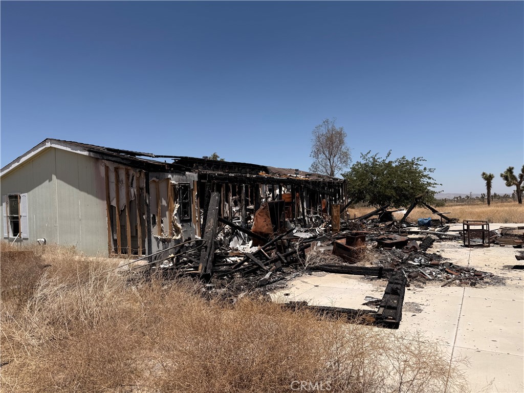 12225 Lager Road Phelan, CA 92371 - Photo 7 of 18 Fire-damaged rear exterior of home