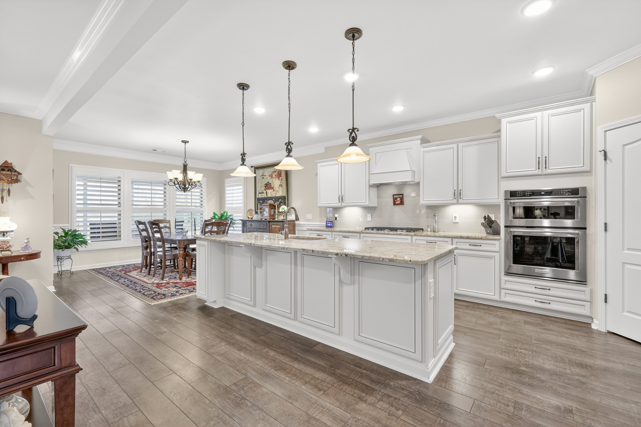 1024 Coffee Ridge Spring Hill, TN 37174 - Photo 14 of 46 a kitchen with stainless steel appliances kitchen island granite countertop a stove a sink and a wooden floors