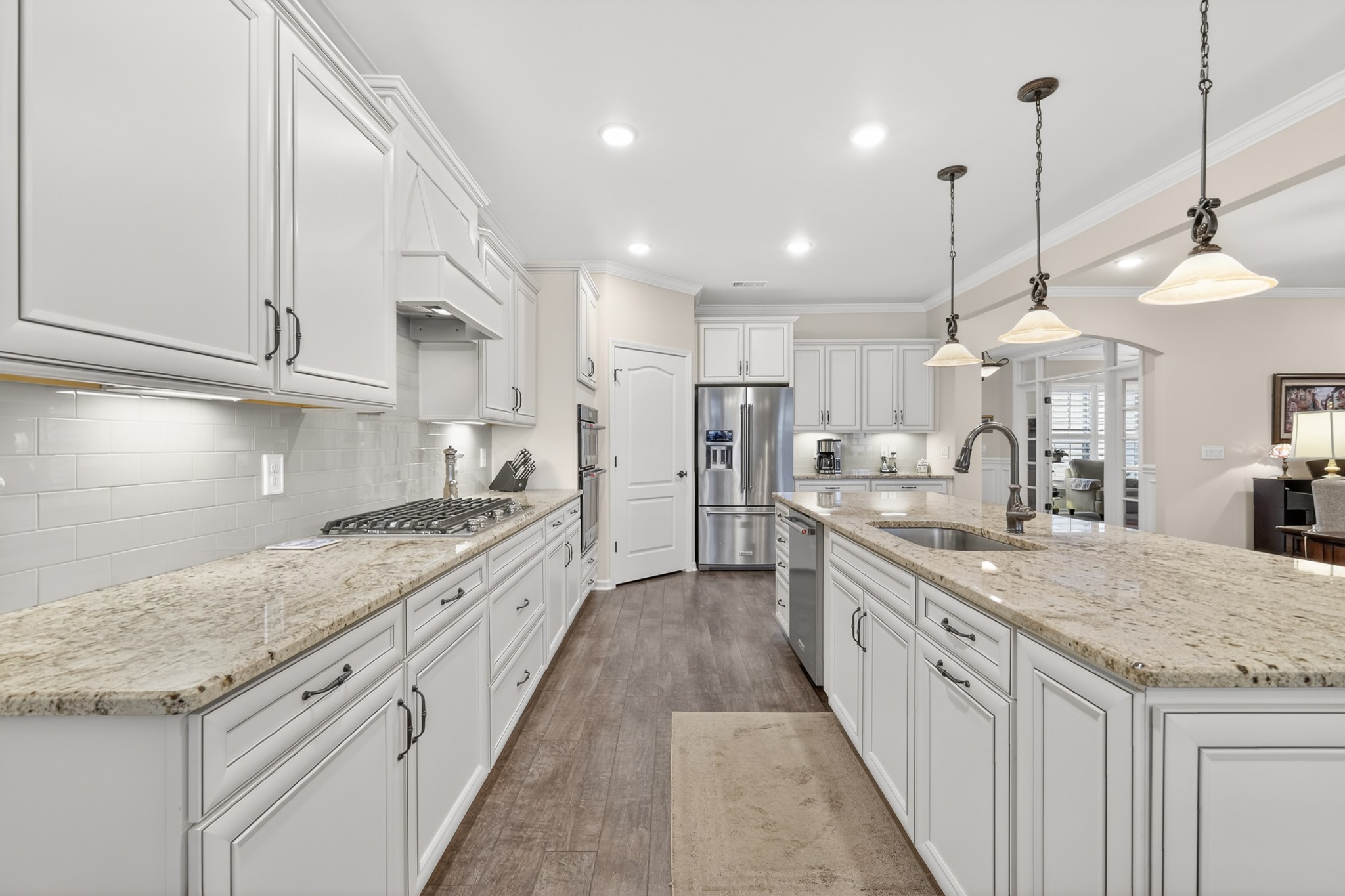 1024 Coffee Ridge Spring Hill, TN 37174 - Photo 18 of 46 a large kitchen with granite countertop a large kitchen island white cabinets and stainless steel appliances