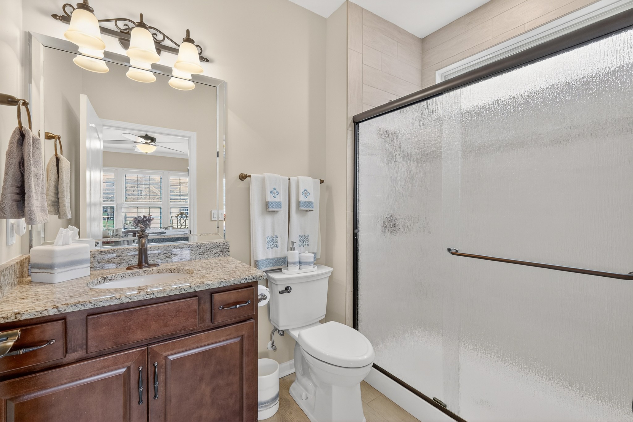 1024 Coffee Ridge Spring Hill, TN 37174 - Photo 24 of 46 a bathroom with a granite countertop sink toilet a mirror and shower