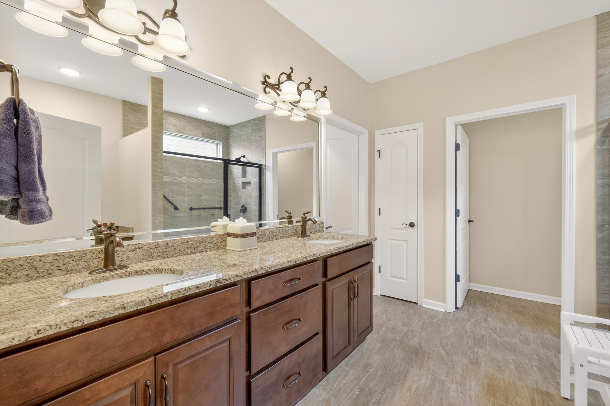 1024 Coffee Ridge Spring Hill, TN 37174 - Photo 27 of 46 a bathroom with a granite countertop double vanity sink a mirror and a shower