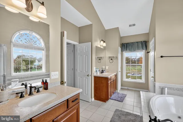 a bath room with a bath tub and a large mirror