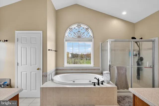 a bathroom with a bathtub sink and mirror