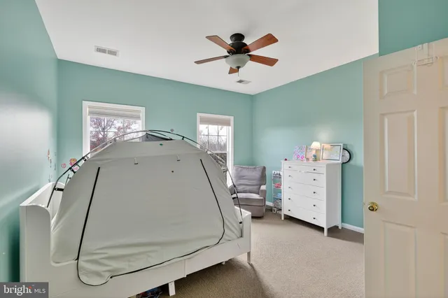 a bathroom with a sink a toilet a shower curtain and a mirror