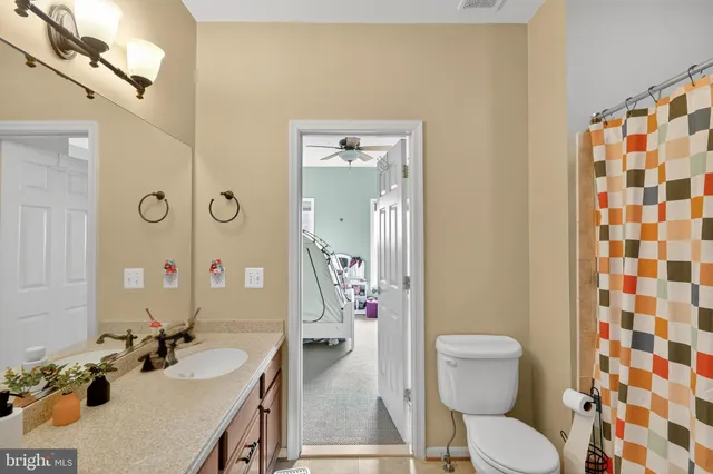 a bedroom with furniture and a fan