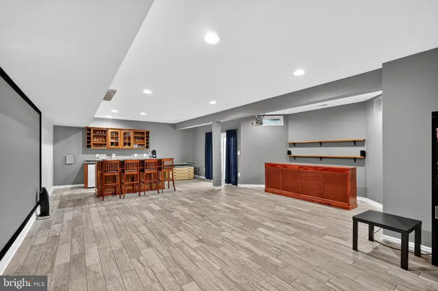 a view of a room with furniture and wooden floor