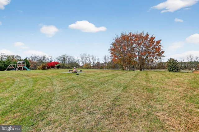 a view of a swimming pool with a table and chairs