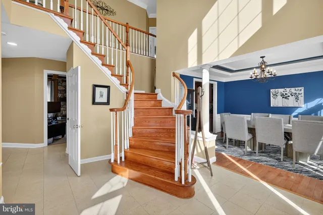 a view of a a dining room with furniture window and wooden floor