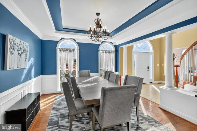 a view of a dining room with furniture and a chandelier