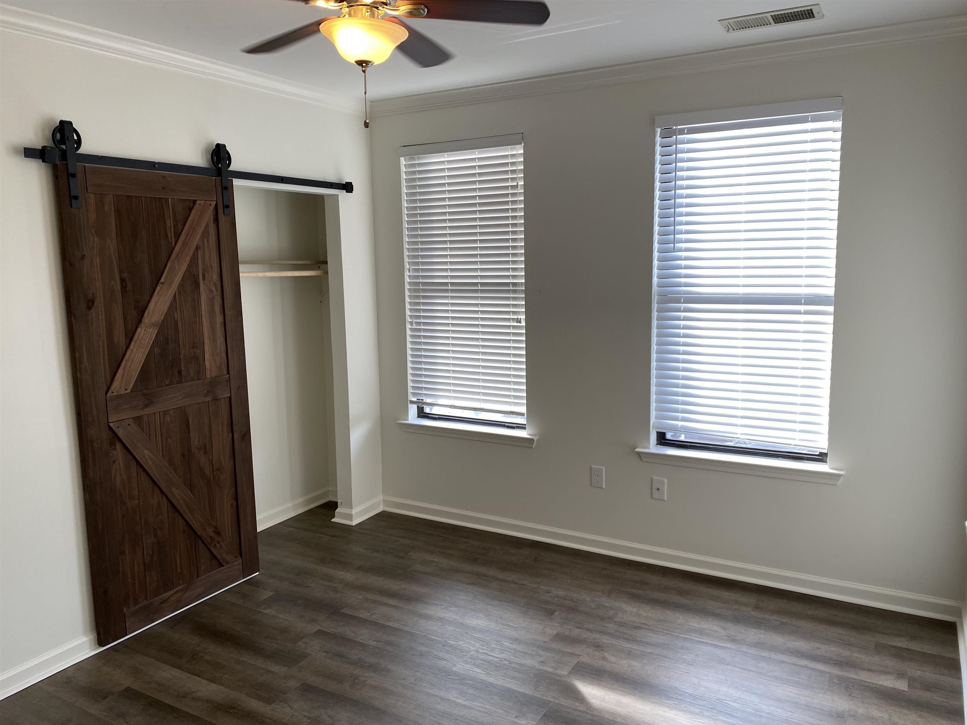 730 Litty Court, Unit 101 Memphis, TN 38103 - Photo 16 of 22 a view of an empty room with wooden floor and a window