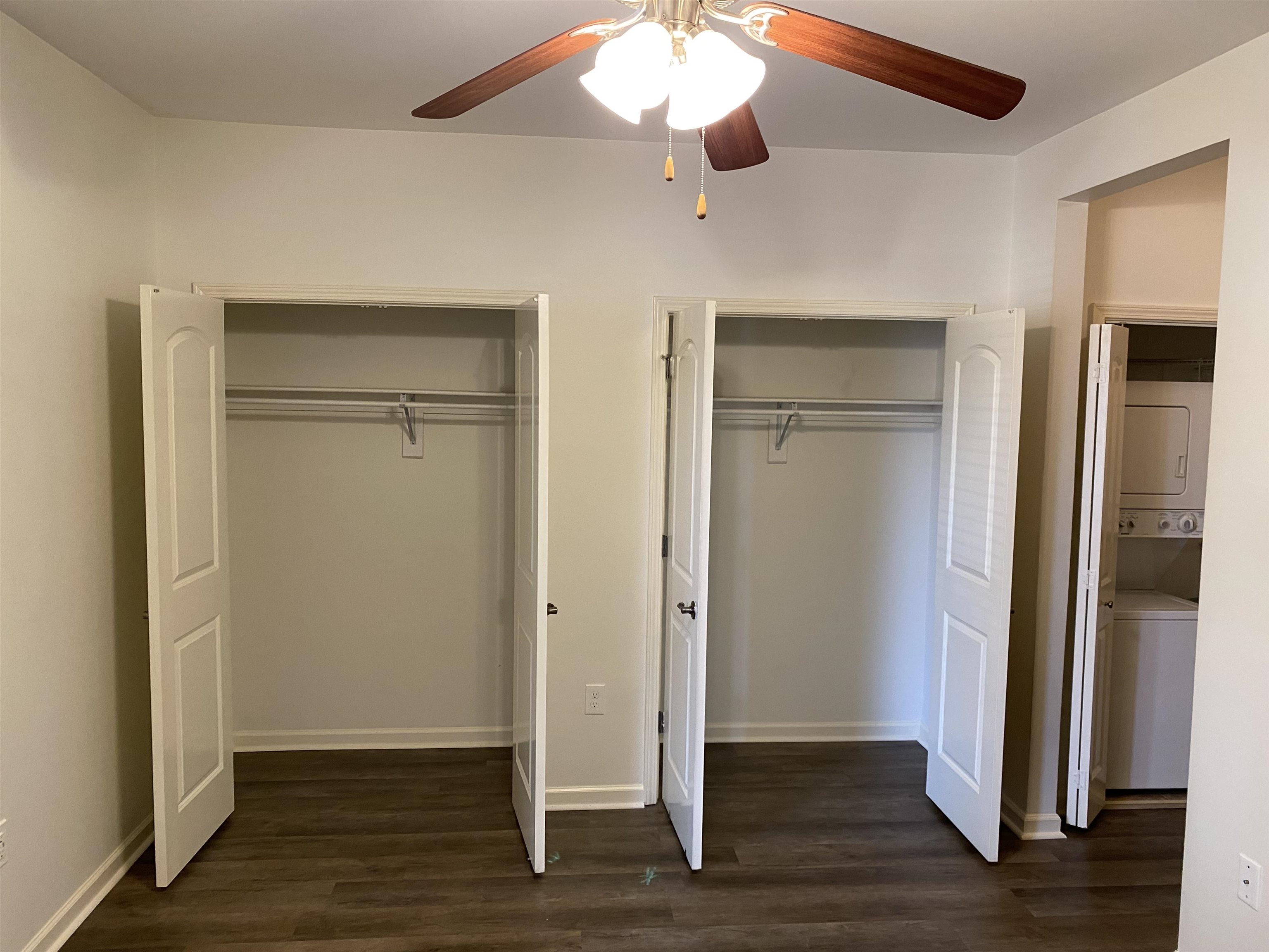 730 Litty Court, Unit 101 Memphis, TN 38103 - Photo 19 of 22 an empty room with wooden floor closet and chandelier fan