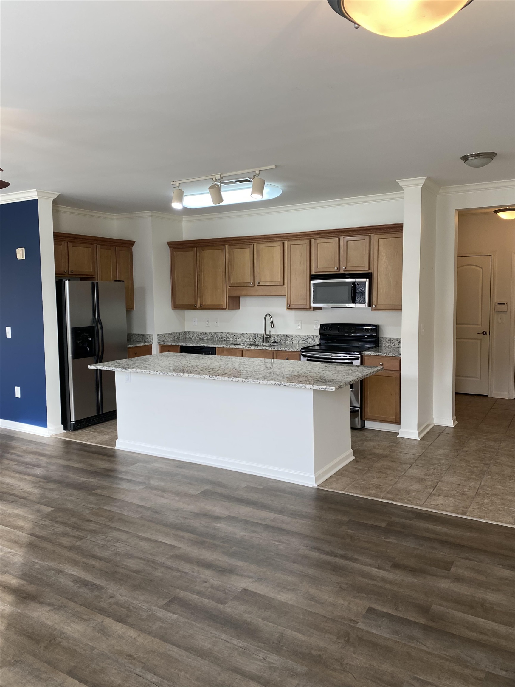 730 Litty Court, Unit 101 Memphis, TN 38103 - Photo 3 of 22 a large kitchen with a center island and stainless steel appliances