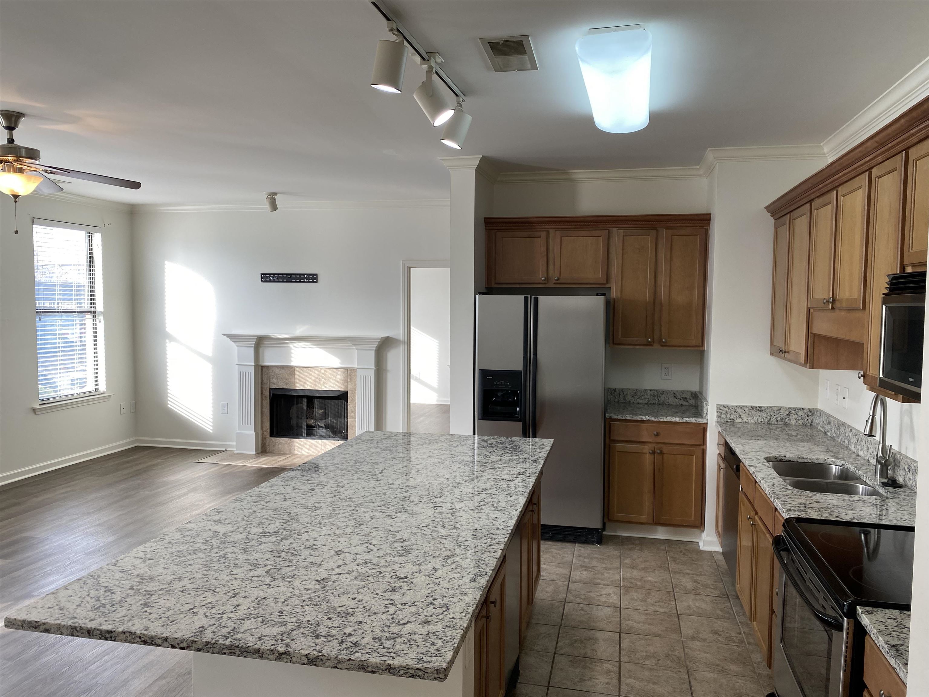 730 Litty Court, Unit 101 Memphis, TN 38103 - Photo 10 of 22 a kitchen with stainless steel appliances granite countertop a sink stove and refrigerator