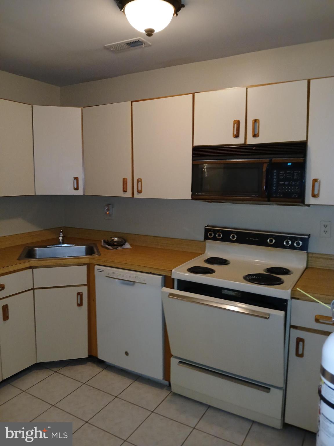 1803 Huntingdon Mews Clementon, NJ 08021 - Photo 9 of 9 a kitchen with granite countertop white cabinets and black appliances